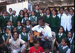John Devaraj singing with children.