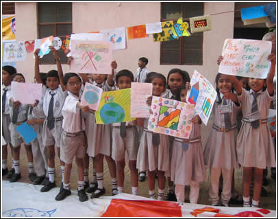 Small children show off their letters at Kapadia.
