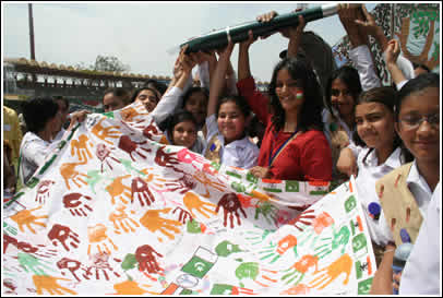 Volunteer Avani stands with a giant symbolic pen which is passed to the Pakistani kids - now it's their turn to write back! 