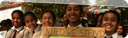 Indian girls with 'United We Stand' Sign